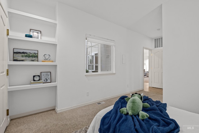 bedroom featuring carpet, visible vents, baseboards, and built in study area