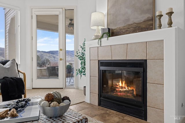 interior space featuring carpet floors, a fireplace, and a mountain view