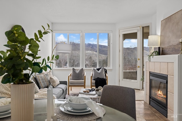 interior space with a tile fireplace