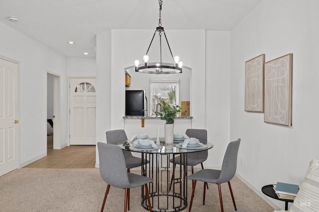 tiled dining area featuring baseboards, recessed lighting, carpet, and a notable chandelier