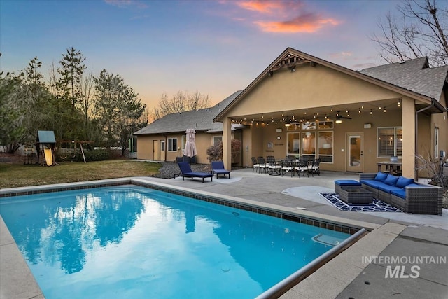 outdoor pool with playground community, an outdoor living space, ceiling fan, a patio area, and a lawn