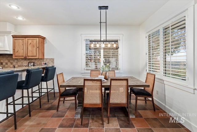 dining space featuring recessed lighting and baseboards