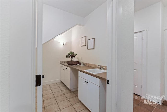 bathroom with tile patterned flooring and vanity