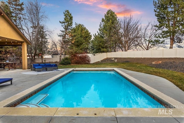 view of swimming pool with an outdoor living space, a patio area, a fenced in pool, and a fenced backyard