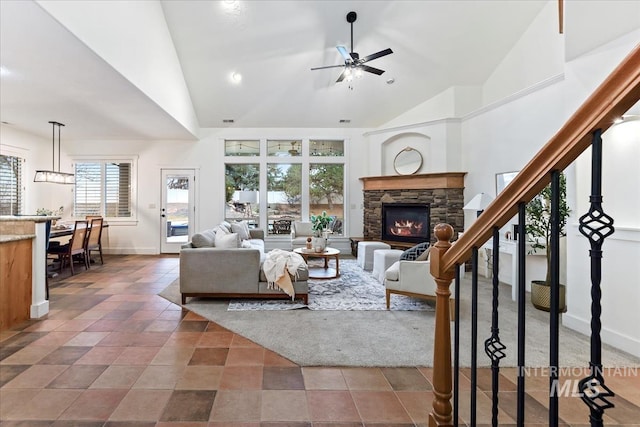 tiled living room featuring baseboards, high vaulted ceiling, ceiling fan, and stairs