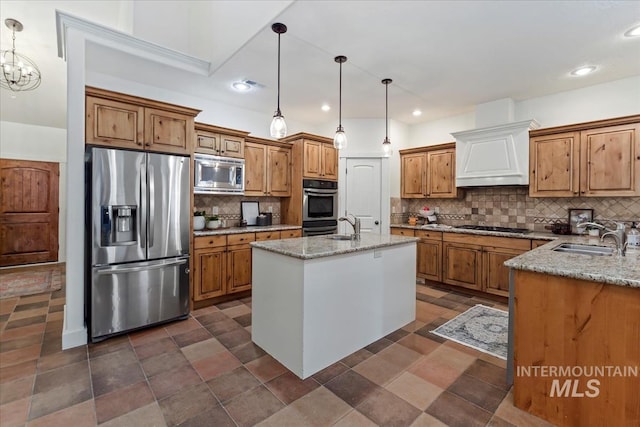 kitchen featuring a sink, stainless steel appliances, custom exhaust hood, and brown cabinetry