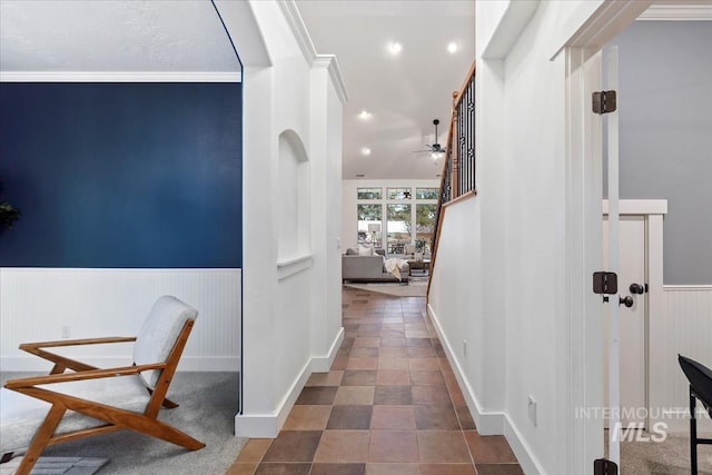 corridor featuring a wainscoted wall, recessed lighting, and crown molding