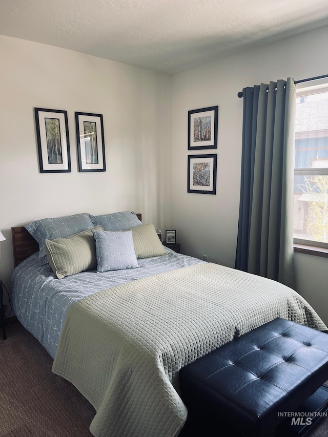 carpeted bedroom with a textured ceiling