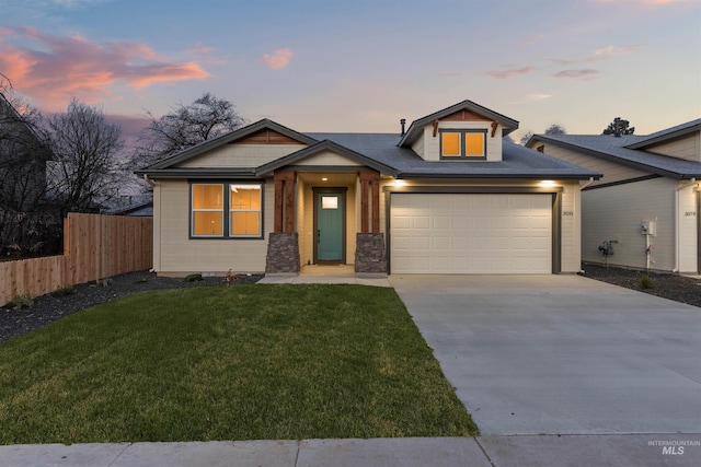 view of front of home featuring a garage and a yard