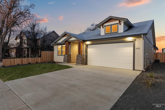 craftsman-style house with a lawn and a garage