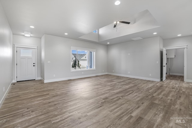 unfurnished living room featuring ceiling fan and light wood-type flooring