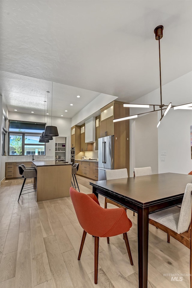 2313 S Aburge Ave, Meridian, ID 83642 - dining room featuring light wood finished floors and recessed lighting