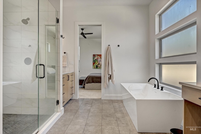 2313 S Aburge Ave, Meridian, ID 83642 - full bath featuring ensuite bath, a soaking tub, a shower stall, a ceiling fan, and tile patterned floors