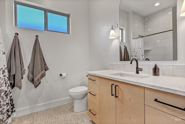 2313 S Aburge Ave, Meridian, ID 83642 - full bath with speckle patterned floor, baseboards, a tile shower, toilet, and vanity