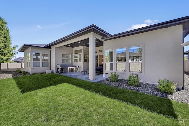 2313 S Aburge Ave, Meridian, ID 83642 - back of house with a patio, a lawn, and stucco siding