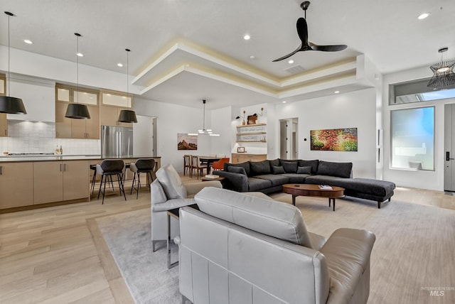 2313 S Aburge Ave, Meridian, ID 83642 - living area featuring light wood finished floors, a ceiling fan, a raised ceiling, and recessed lighting