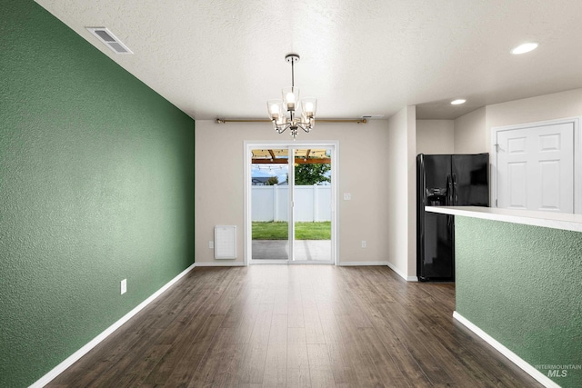 942 S Stibnite Pl, Kuna, ID 83634 - unfurnished dining area with a textured wall, a chandelier, dark wood-type flooring, baseboards, and recessed lighting