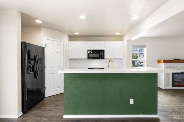 942 S Stibnite Pl, Kuna, ID 83634 - kitchen featuring black appliances, white cabinets, dark wood-type flooring, light countertops, and decorative backsplash