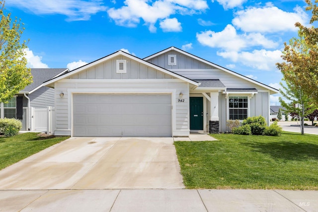 942 S Stibnite Pl, Kuna, ID 83634 - view of front of home with board and batten siding, an attached garage, driveway, and a shingled roof