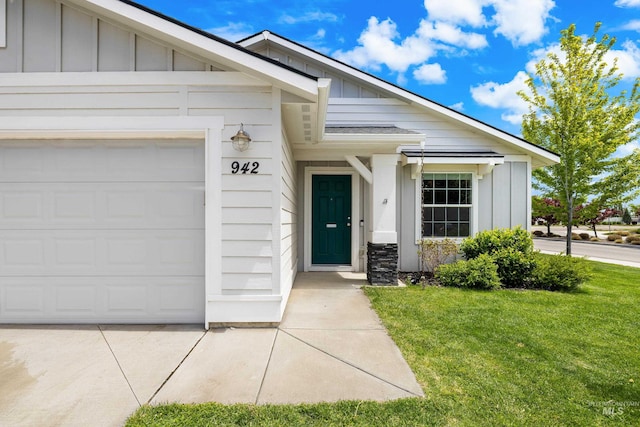 942 S Stibnite Pl, Kuna, ID 83634 - view of exterior entry with board and batten siding, a yard, and an attached garage