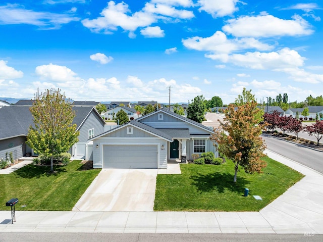 942 S Stibnite Pl, Kuna, ID 83634 - ranch-style house with board and batten siding, a garage, a front lawn, and concrete driveway