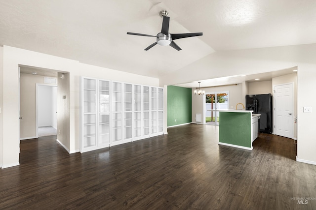 942 S Stibnite Pl, Kuna, ID 83634 - unfurnished living room with ceiling fan, a chandelier, lofted ceiling, dark wood-style flooring, and baseboards