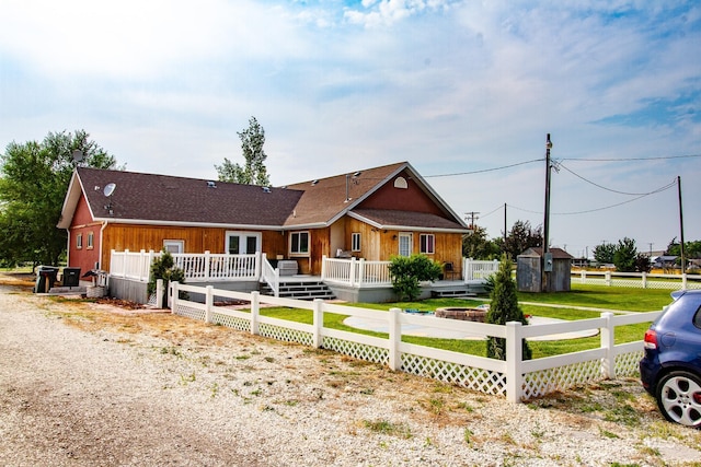 view of front of home featuring a deck and a storage unit