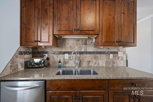 kitchen with dishwasher, tasteful backsplash, light stone countertops, and a sink