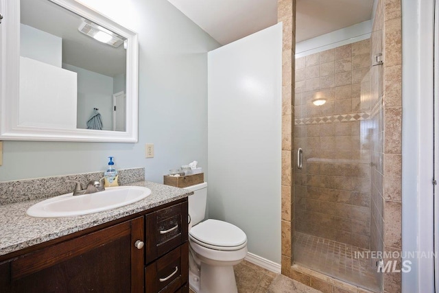 bathroom featuring a shower stall, vanity, toilet, tile patterned flooring, and visible vents