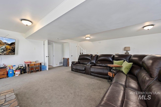 carpeted living room with stairway and visible vents