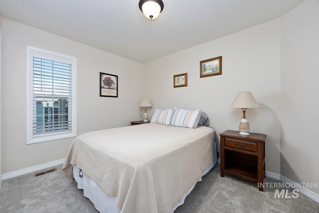 bedroom featuring carpet floors, visible vents, and baseboards