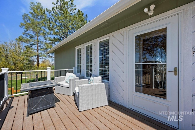 wooden terrace featuring a fire pit