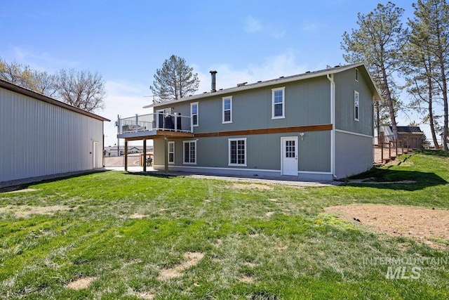 back of property with a yard and a deck