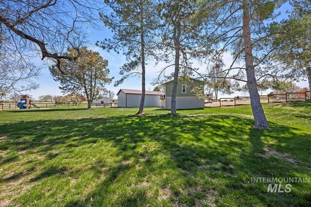 view of yard featuring a playground and fence