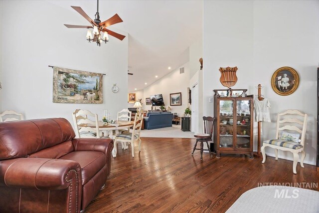 living area featuring high vaulted ceiling, a ceiling fan, and wood finished floors