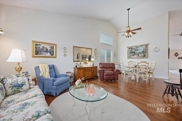 living area with a ceiling fan, high vaulted ceiling, and wood finished floors