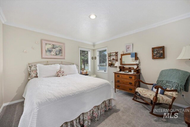 bedroom with carpet, crown molding, and baseboards