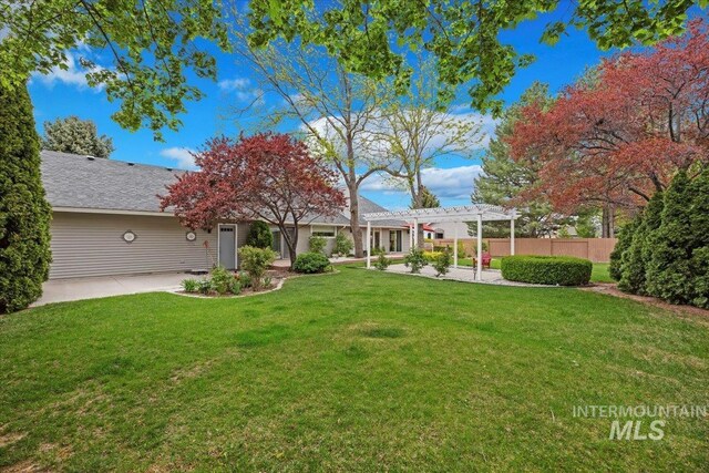 view of yard with a pergola and a patio