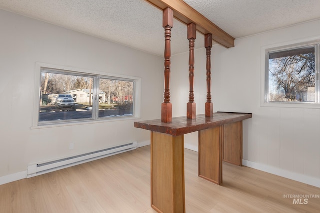 details with beam ceiling, baseboard heating, wood finished floors, and a textured ceiling