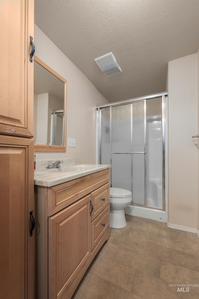 bathroom featuring vanity, visible vents, and a stall shower