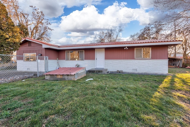 ranch-style house with crawl space, stone siding, a front yard, and fence