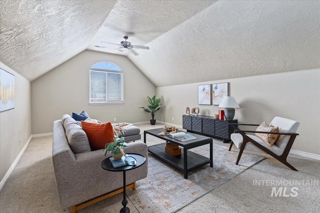 living room featuring carpet flooring, ceiling fan, lofted ceiling, and a textured ceiling