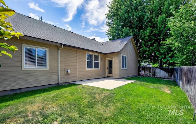 rear view of property with a lawn and a patio