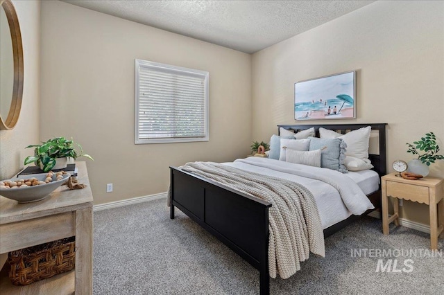 carpeted bedroom featuring a textured ceiling