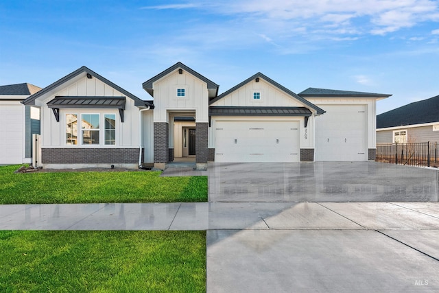 view of front of home with a garage and a front lawn