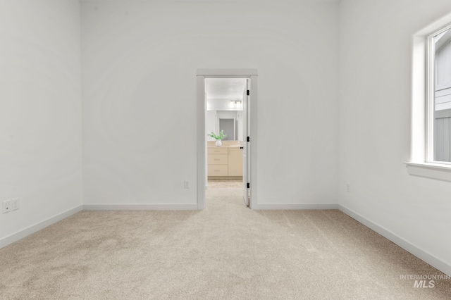 empty room with baseboards and carpet flooring