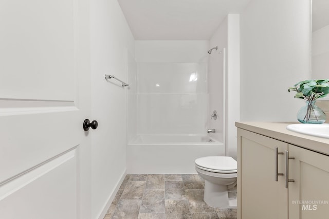 full bathroom with toilet, stone finish flooring, shower / bathing tub combination, and vanity