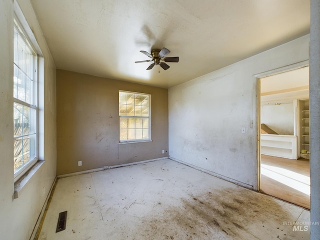 unfurnished room with plenty of natural light and ceiling fan