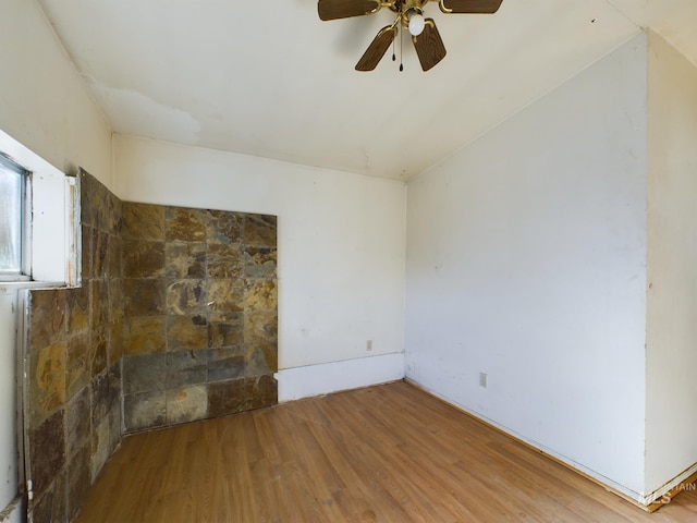 spare room with hardwood / wood-style floors and ceiling fan