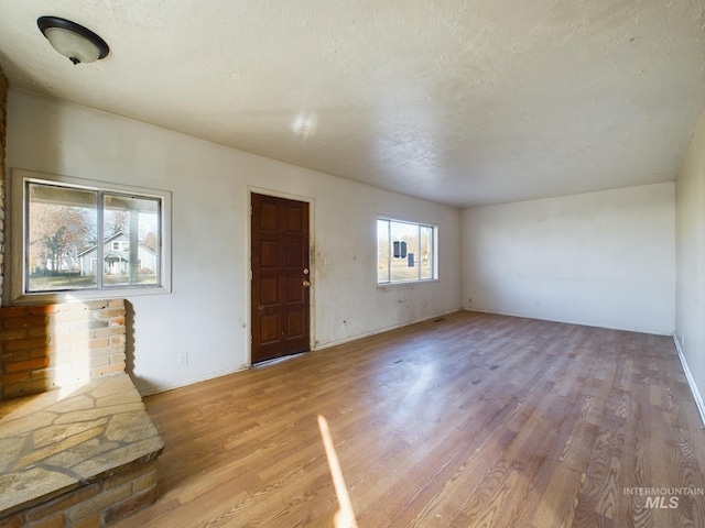 interior space with light hardwood / wood-style floors and a textured ceiling